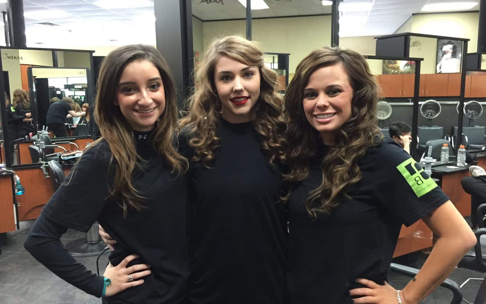 Three students in black on the Student Salon floor